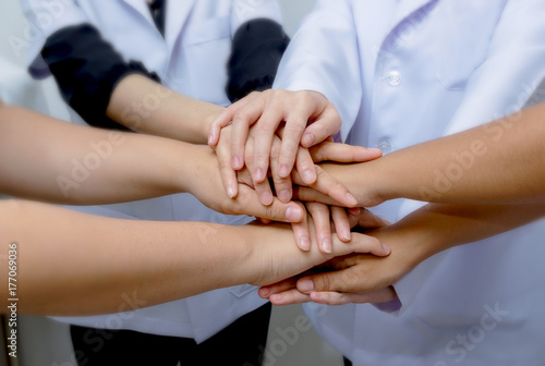 Doctors and nurses in a medical team stacking hands Medical team cooperation