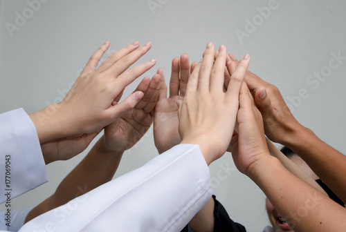 Doctors and nurses in a medical team stacking hands Medical team cooperation