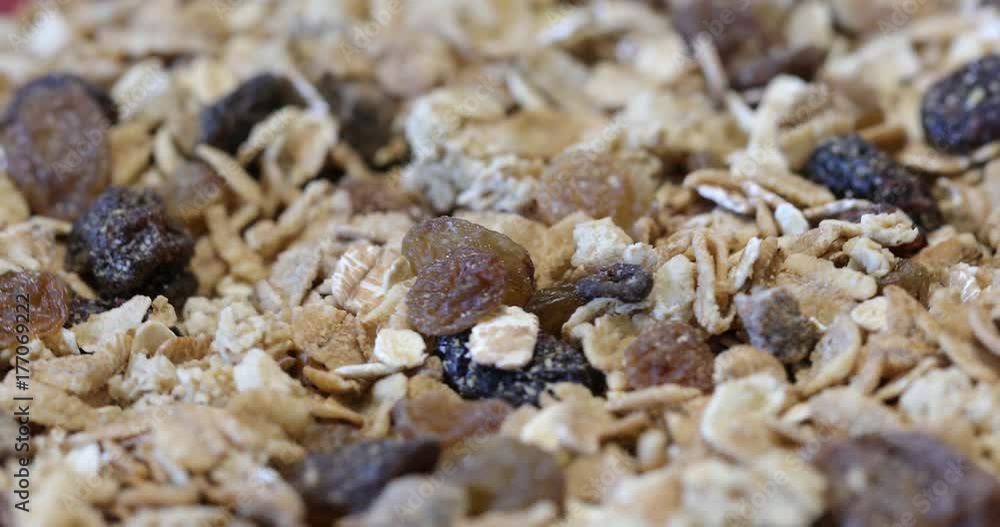 Granola texture, muesli texture,close photo image on granola or muesli pile present a detail in view of granola or muesli texture, a cereal grain healthy food, can use for background ( 4k ungraded ) Granola texture, muesli texture,close photo image on granola or muesli pile present a detail in view of granola or muesli texture, a cereal grain healthy food, can use for background ( 4k ungraded )