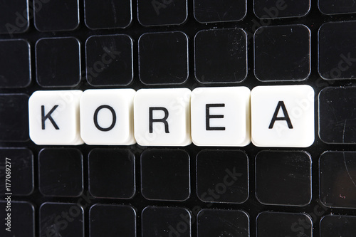 Korea text word crossword. Alphabet letter blocks game texture background.