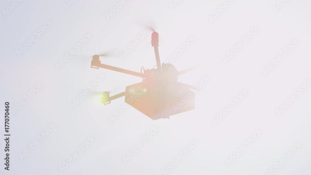 CLOSEUP LENS FLARE UAV drone delivering goods. Last minute gift delivery by cargo multicopter. Shipping drone bringing birthday present to your home. Futuristic drone flying Christmas present over sun CLOSEUP LENS FLARE UAV drone delivering goods. Last minute gift delivery by cargo multicopter. Shipping drone bringing birthday present to your home. Futuristic drone flying Christmas present over sun
