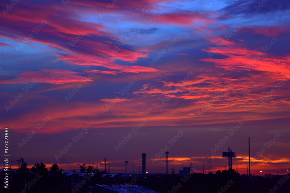 Silhouette of the electrical Pole and crane tower in Sunrise sky.