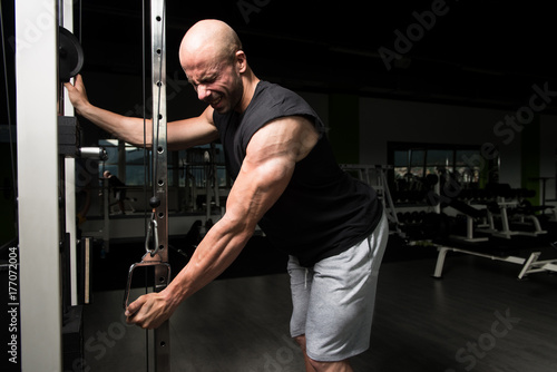 Bodybuilder Doing Heavy Exercise For Triceps With Cable © Jale Ibrak