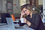 Young and beautiful businesswoman tired from work in the office.Woman holding her head.