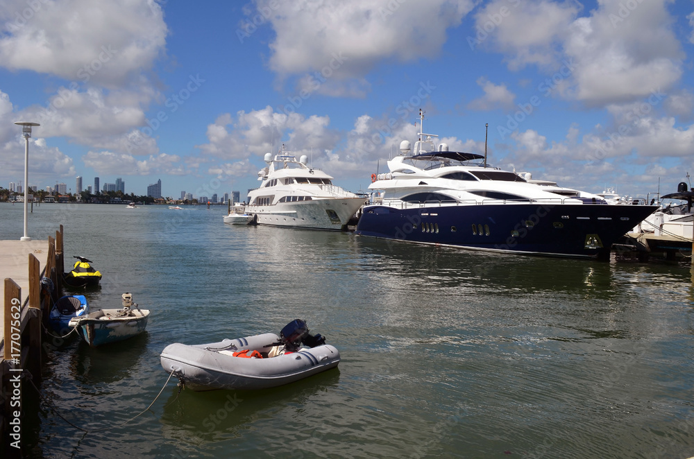 Luxury yachts and small watercraft docked at a marina-condo complex on Miami Beach ,Florida Luxury yachts and small watercraft docked at a marina-condo complex on Miami Beach ,Florida