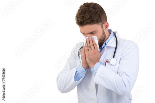 Doctor sneezing isolated against white background