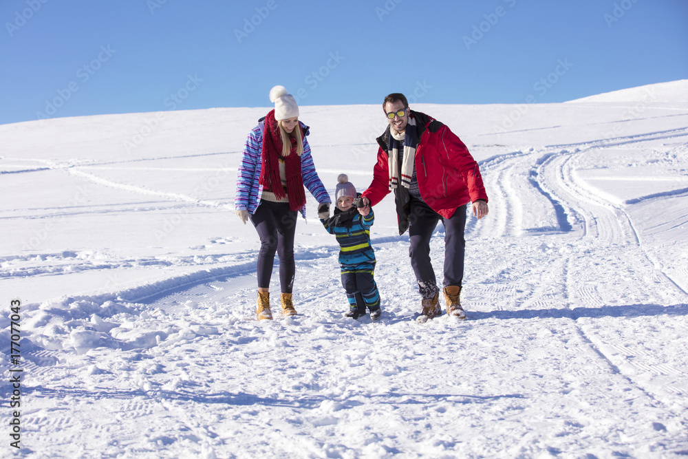 Attractive family having fun in a winter park on mountain