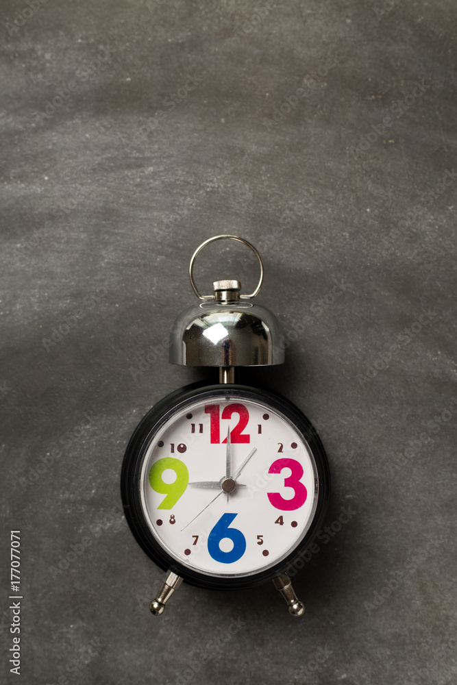 Round vintage clock on grey background. School concept.
