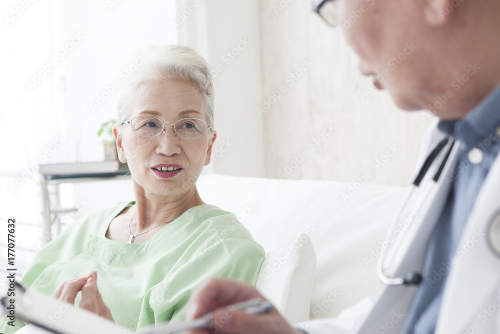An old female patient is talking to a doctor An old female patient is talking to a doctor