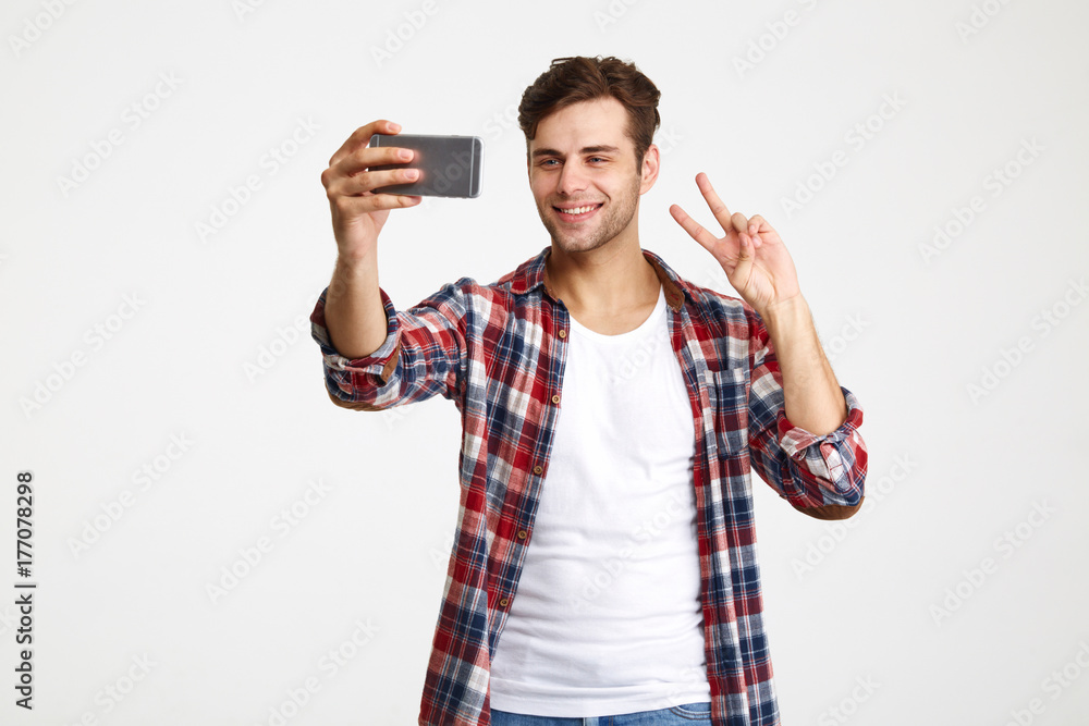 Portrait of a smiling attractive man taking a selfie Portrait of a smiling attractive man taking a selfie
