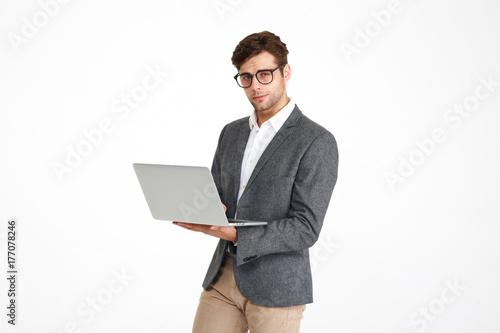 Portrait of a young smiling businessman in eyeglasses