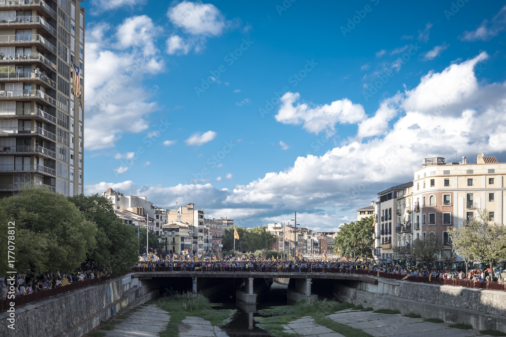 Crowd filling the streets in Girona riverwalk view Crowd filling the streets in Girona riverwalk view