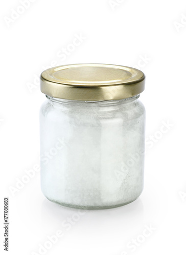 Glass jar with fresh coconut oil isolated on white background.