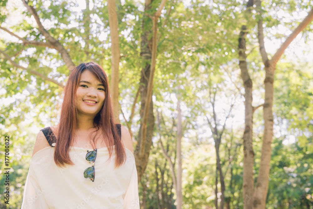 Enjoying the nature. Young asian woman arms raised enjoying the fresh air in green forest. Enjoying the nature. Young asian woman arms raised enjoying the fresh air in green forest.