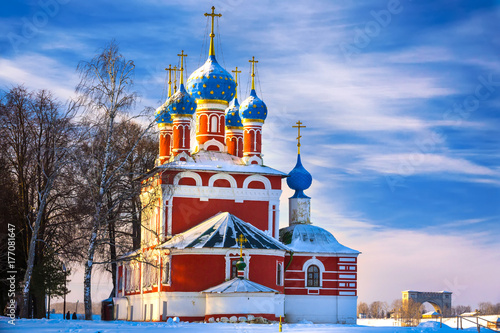 Russian Orthodox Church in Uglich on the background of a cold winter sunny blue sky. Cathedral in the snow covered city. photo