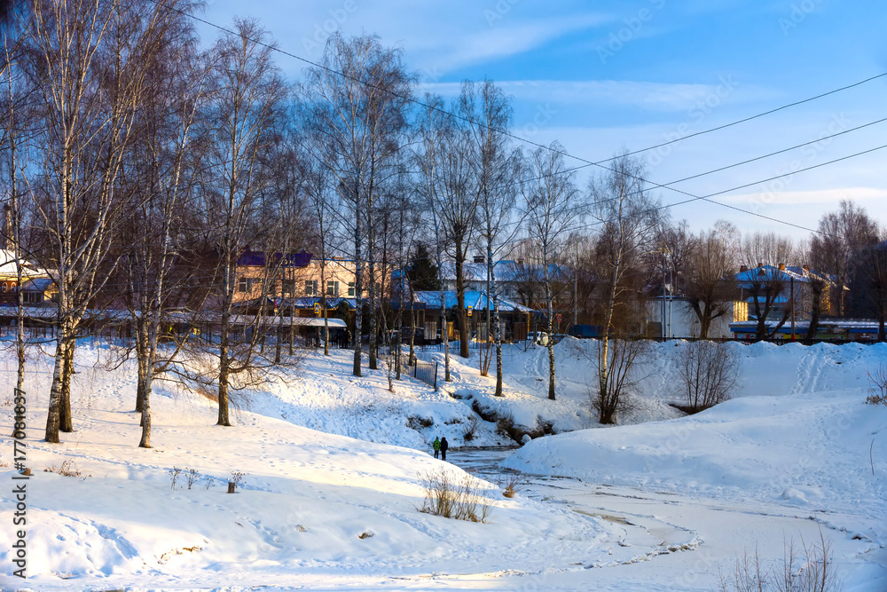 Children walk on thin ice on the river. Winter Russia, Uglich.