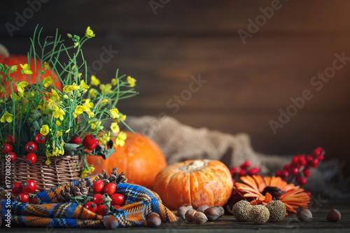 The table decorated with flowers and vegetables. Happy Thanksgiving Day. Autumn background.