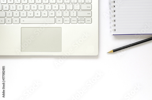 Laptop and note book and pencil on white background.