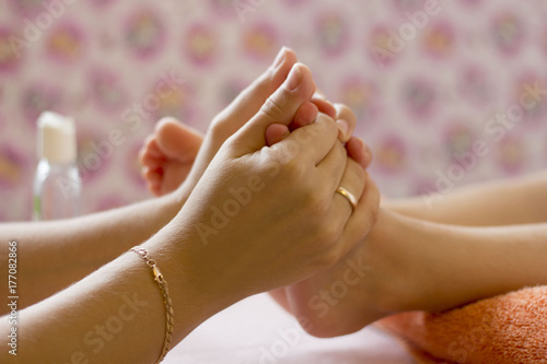 female hands doing massage of feet child