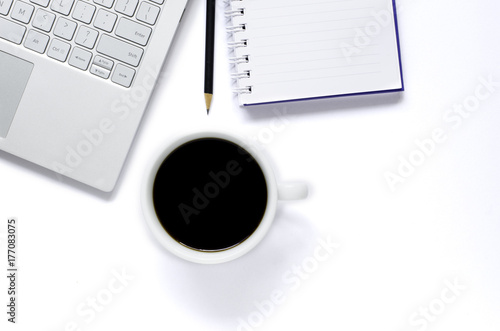 Laptop and note book and pencil and black coffee on white background.