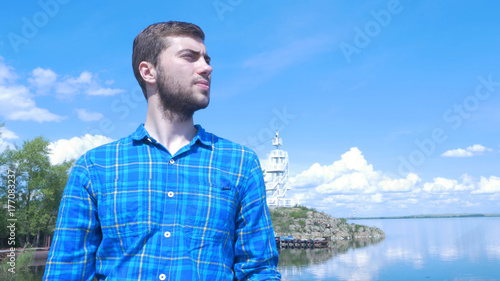 Handsome man of the ship and looking to the city.Man ,stylish boy,blue shirt,pretty boy,attractive,spring vacations,ferry,casual wear,man at the sea,bracelets © Media Whale Stock