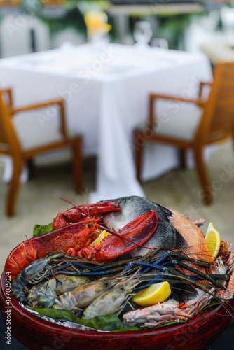 Fresh seafood, lobster, prawn, fish, crab, squid & meat in the wooden bowl ready for grill.