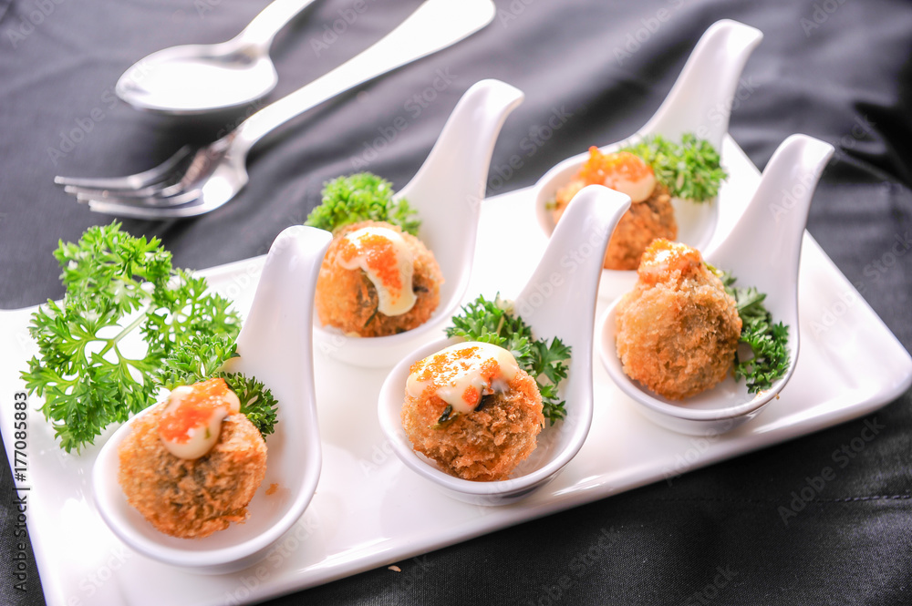 appetizer of meat ball and spawn on spoon appetizer of meat ball and spawn on spoon