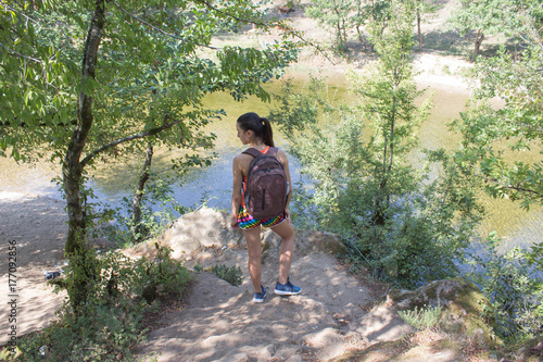 Eco tourism and healthy lifestyle concept. Young hiker girl with backpack. Active hiker