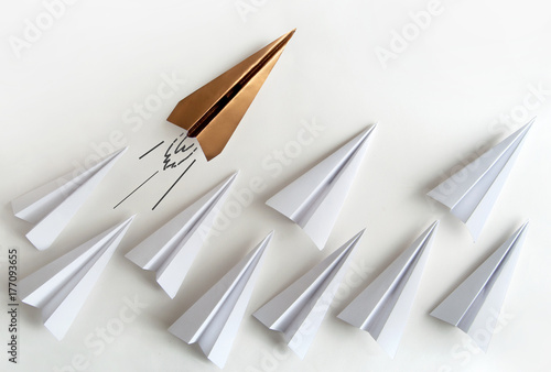 Gold paper plane leader con...