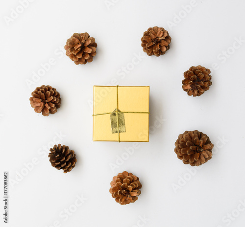 Christmas ornamate brown gift box and pine cones fresh green branch on white background,flat lay photo