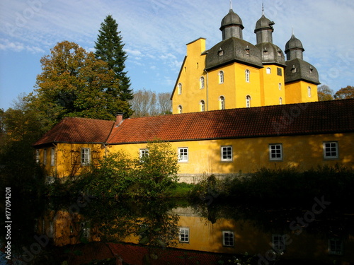 Leuchtende Fassade in Beige und Ocker von Schloß Holte im Herbst bei Sonnenschein in Schloß Holte-Stukenbrock bei Gütersloh in Ostwestfalen-Lippe photo