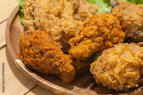 fried chickens on wooden plate