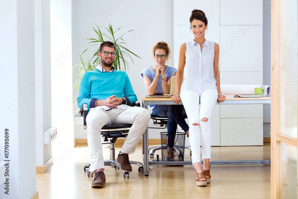 Group of business people looking at camera in modern office. Group of business people looking at camera in modern office.