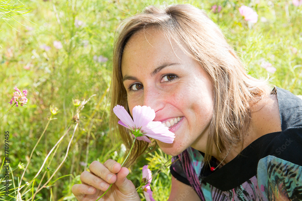 Beautiful Young Woman lying in Meadow of Flowers. Enjoy Nature Beautiful Young Woman lying in Meadow of Flowers. Enjoy Nature