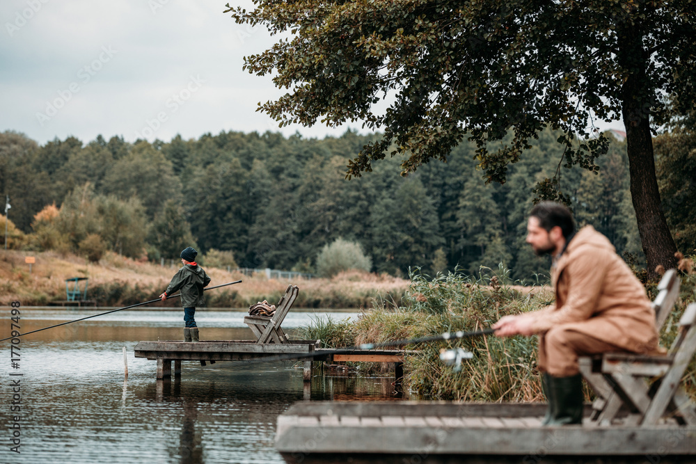 Fototapeta premium Father and son fishing on piers