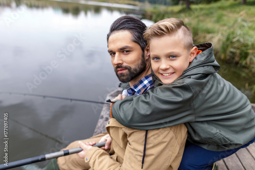 Father and son fishing with rods © LIGHTFIELD STUDIOS