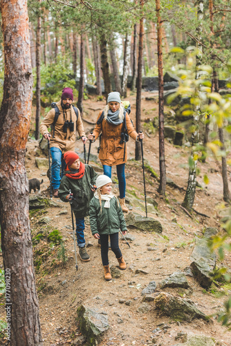 family walking in autumn forest
