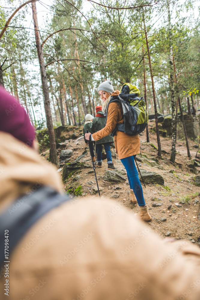 smiling woman trekking with family smiling woman trekking with family