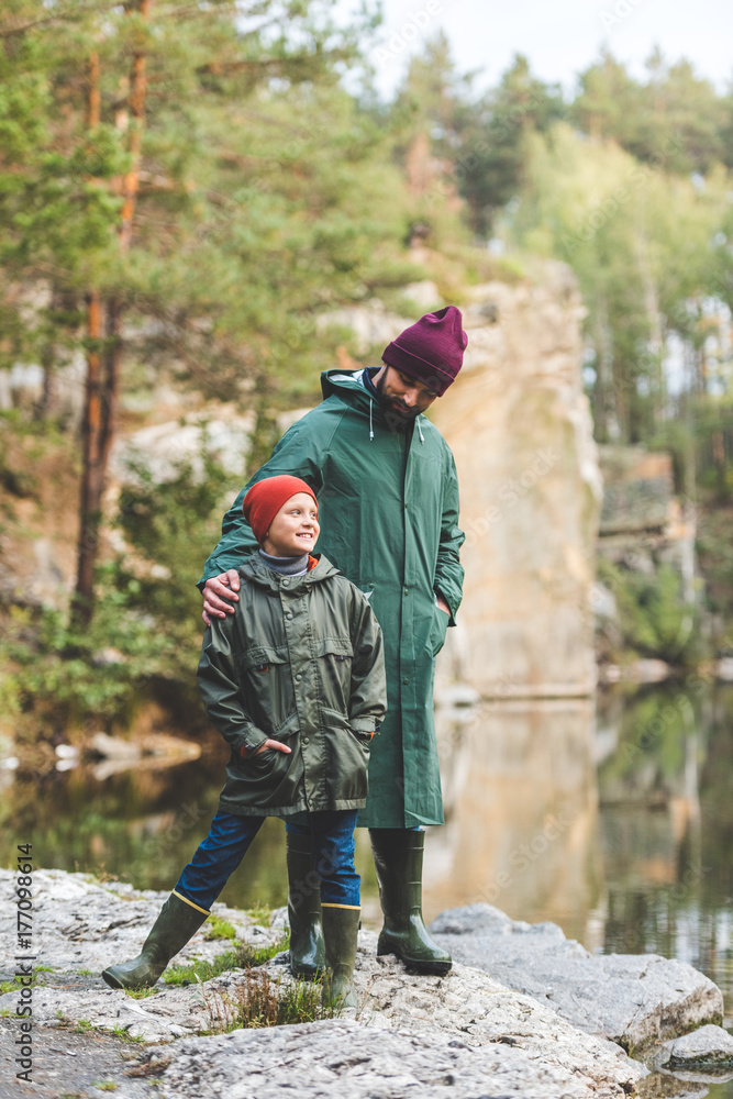 father and son in autumn forest