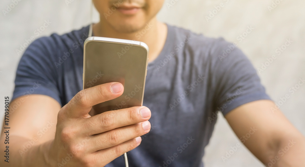 Man listening to a music from smartphone.