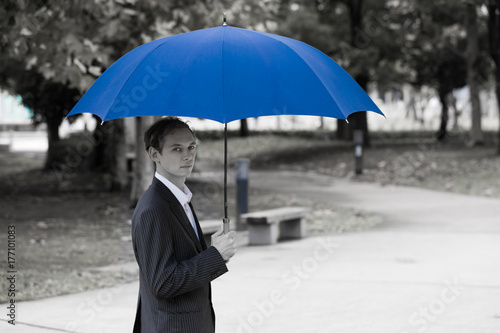 Middle aged man putting up an umbrella © metamorworks