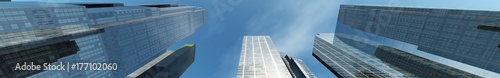 Skyscrapers. A view from below on a modern building against the sky with clouds. banner. 3D rendering 