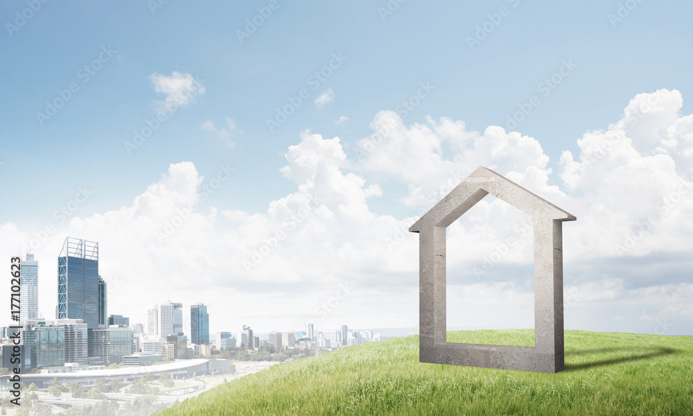 Conceptual image of concrete home sign on hill and natural landscape at background