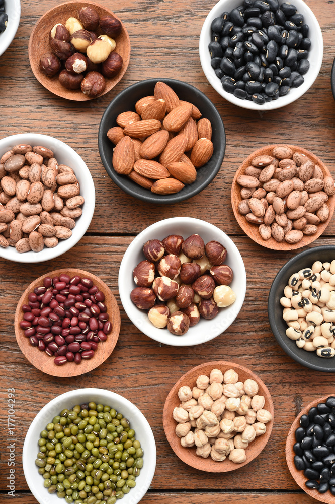 Assortment of beans and lentils in wooden spoon on teak wood background Assortment of beans and lentils in wooden spoon on teak wood background