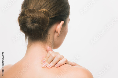 Young woman having stiff shoulders.