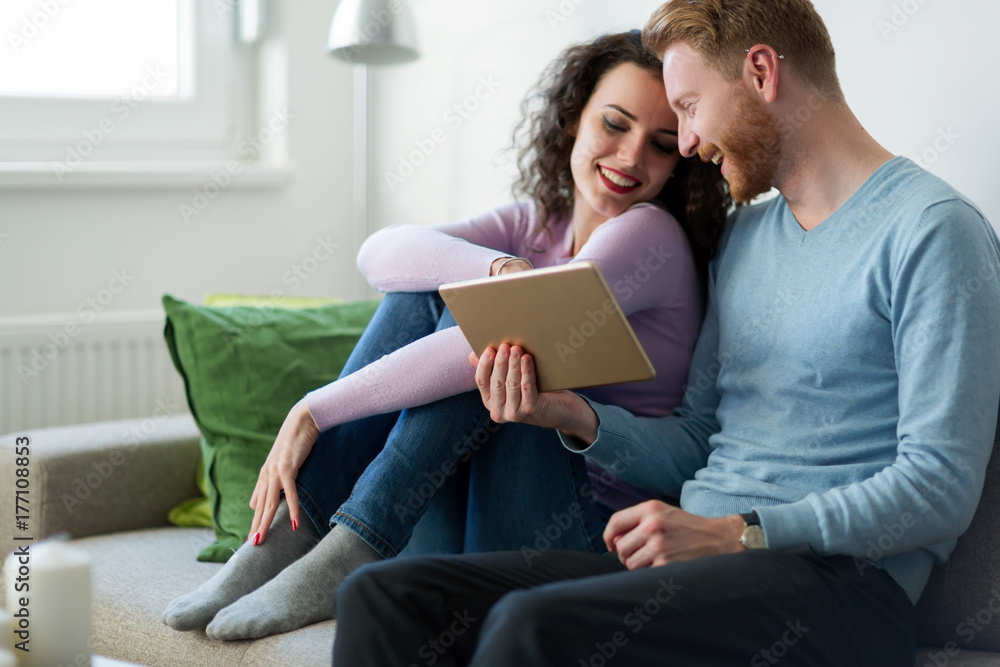 Young couple using digital tablet at home Young couple using digital tablet at home