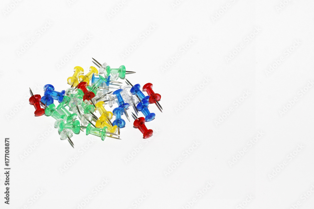 colorful pins on the white background with copy space colorful pins on the white background with copy space