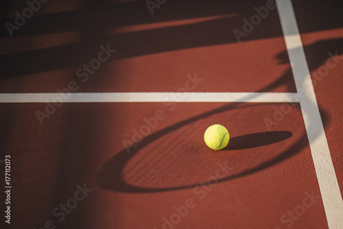 Balls and racket on tennis court