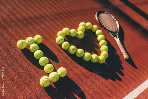 Balls and racket on tennis court © Vasyl