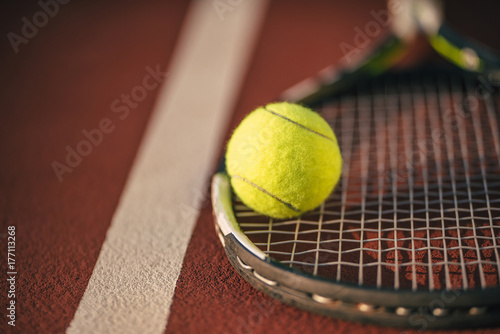 Balls and racket on tennis court